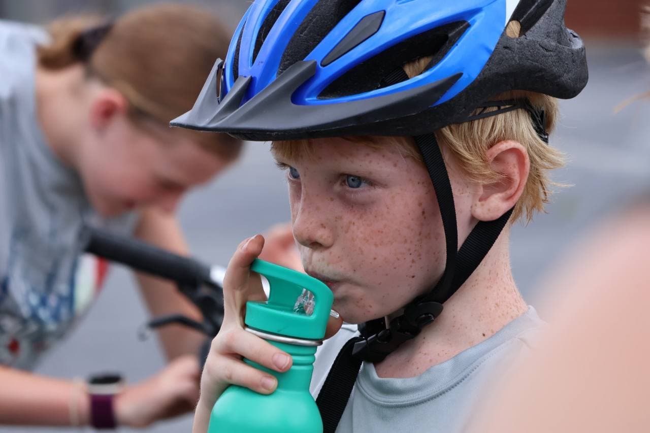 A young Cycle for Hope rider taking a water break